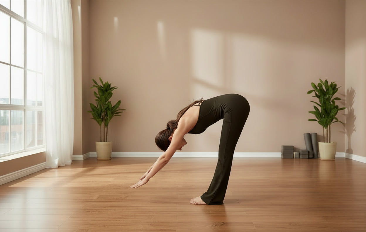Woman wearing a ebony jumpsuit with criss-cross straps in a yoga studio