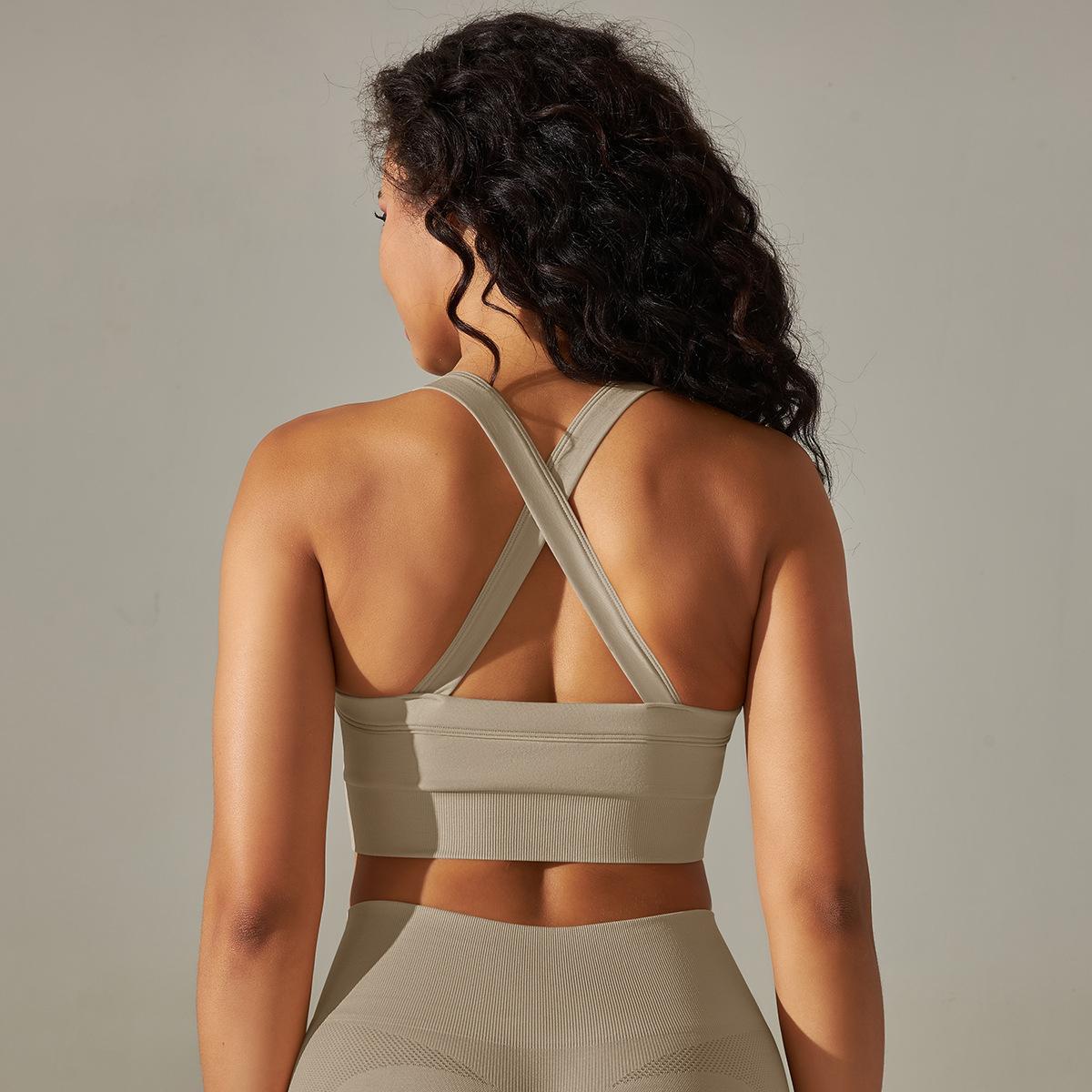Woman wearing a Khaki sports bra and leggings against a neutral background